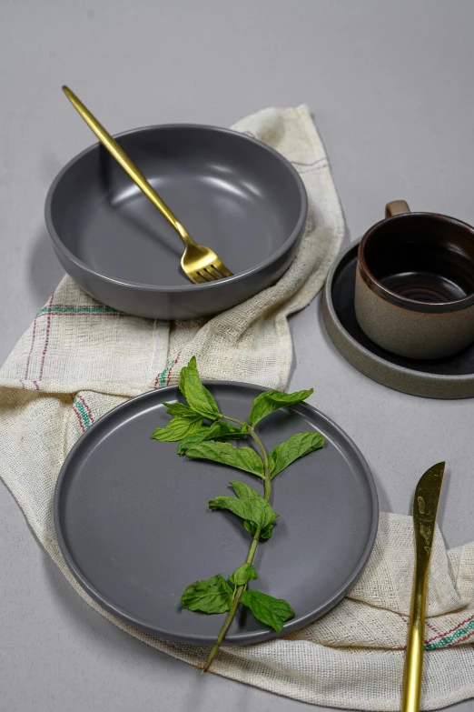 a metal place setting with flowers in vase