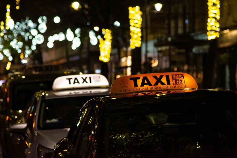 taxi cabs are on the street of a city