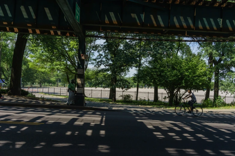 two people riding their bikes through the park