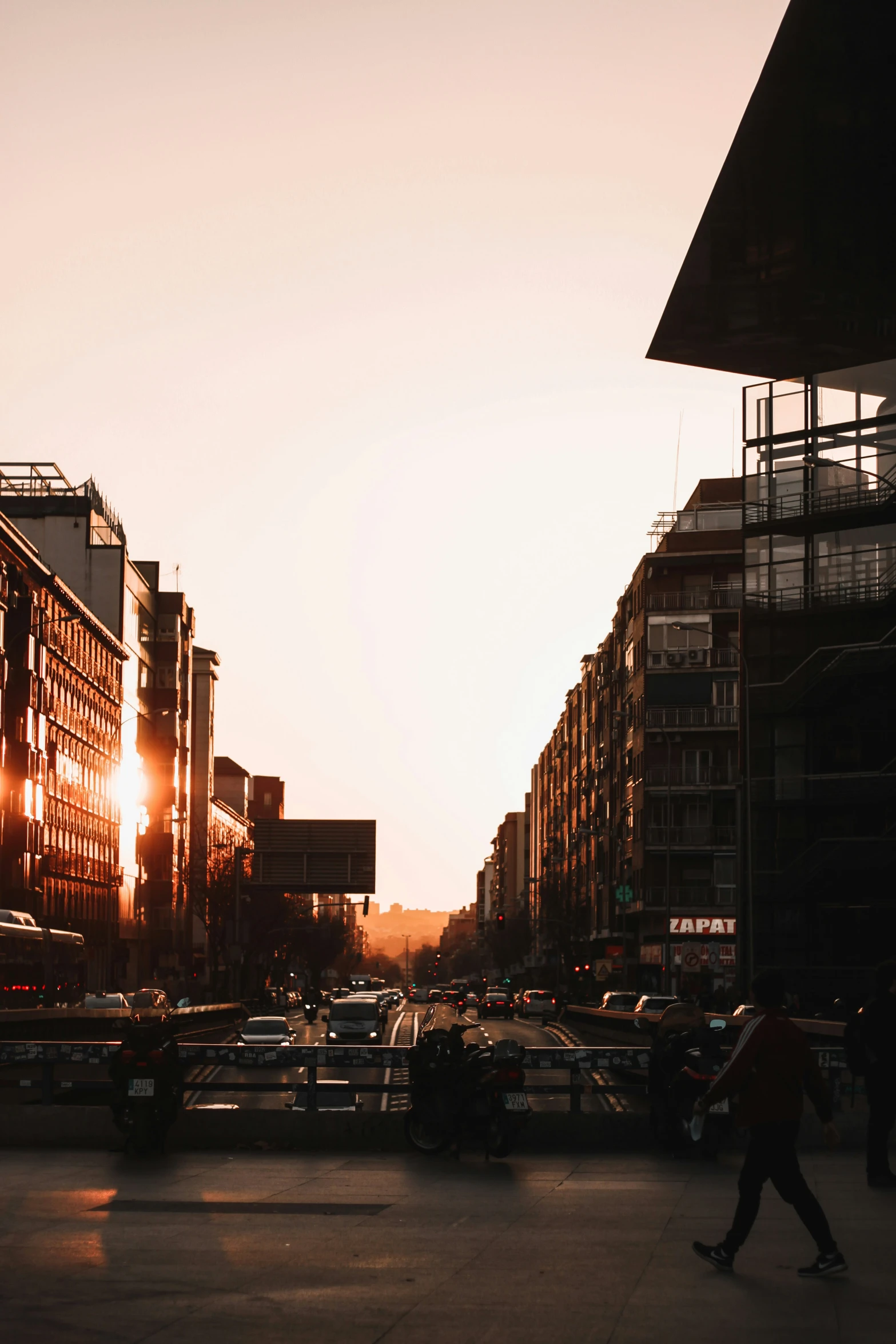 a person skateboarding in a big city during the sun set