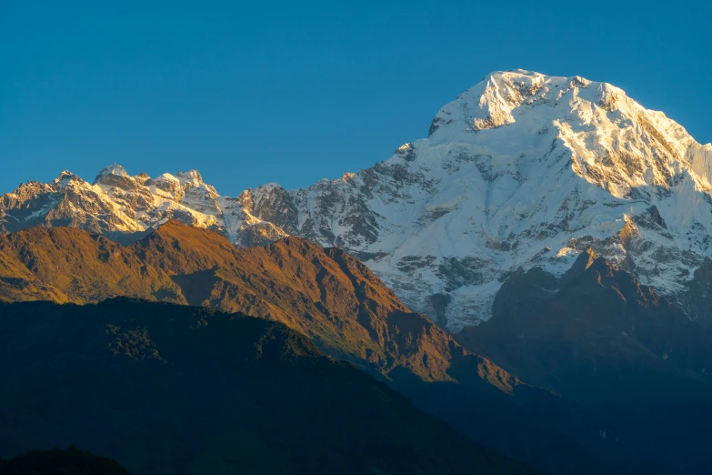 the peaks of the mountain are covered in snow