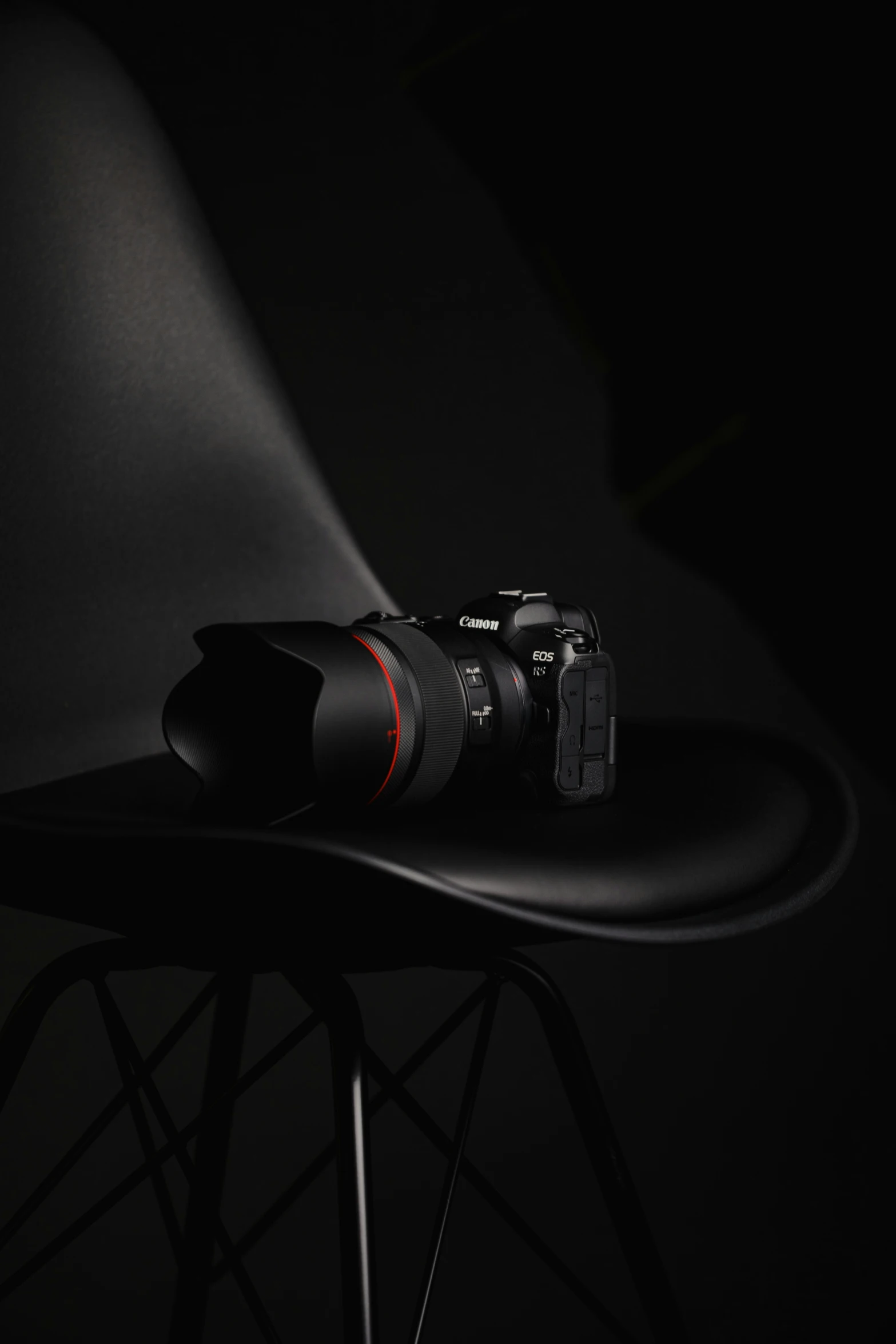 a camera sitting on top of a black chair