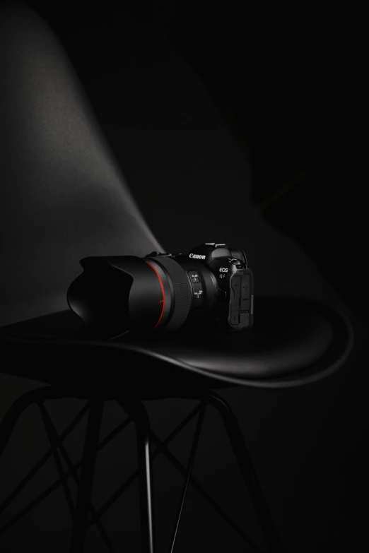 a camera sitting on top of a black chair