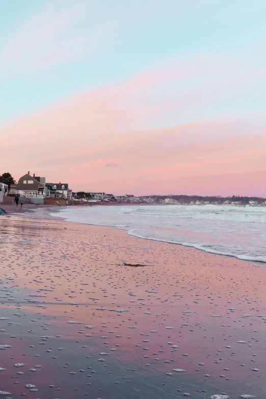 a person walking along a beach with an umbrella