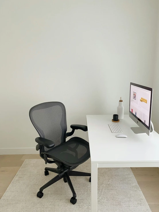 a desk and chair with a computer monitor on it