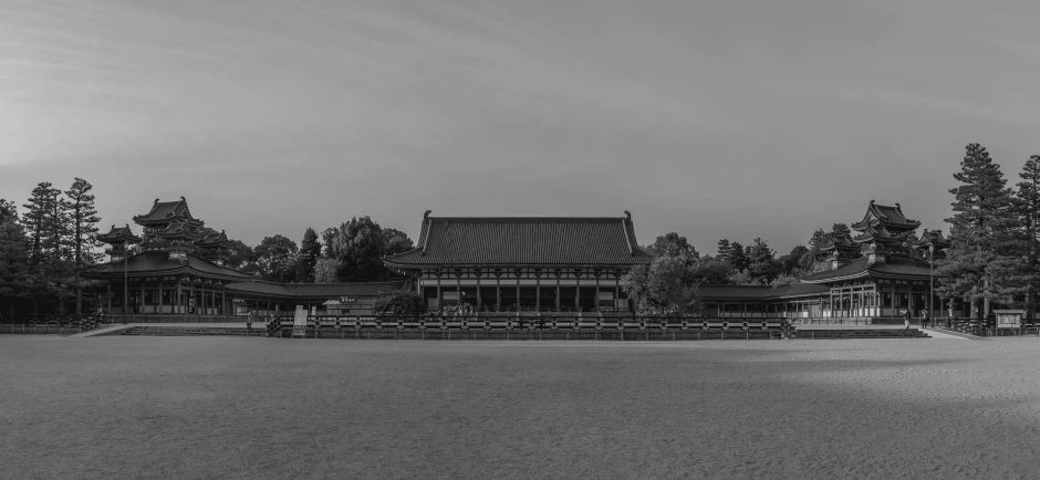 black and white pograph of a building surrounded by trees