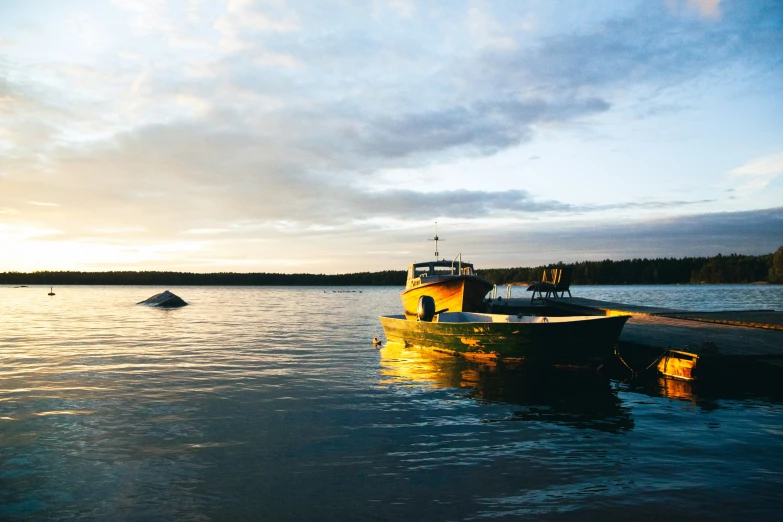 a couple of boats sit on the water