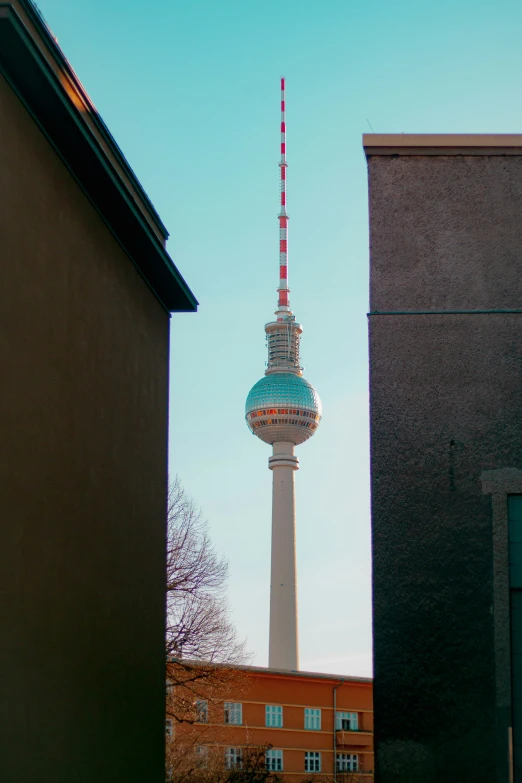 the tall tower has a red and white top