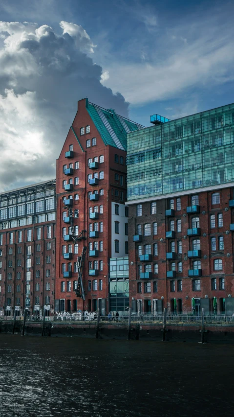 an older building in the middle of the ocean under cloudy skies