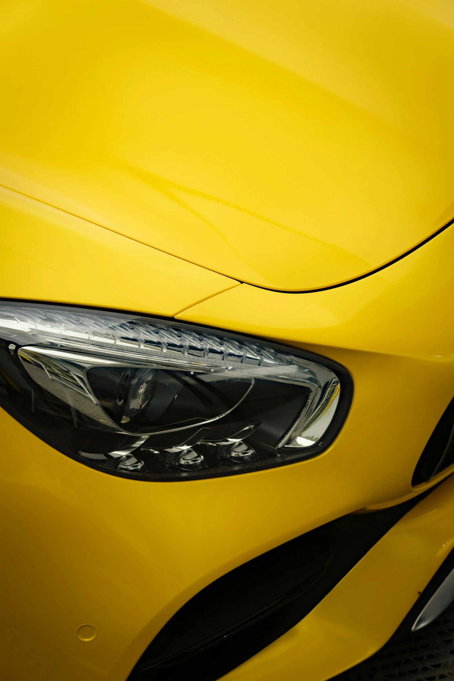 a close up view of the headlight and front end of a car