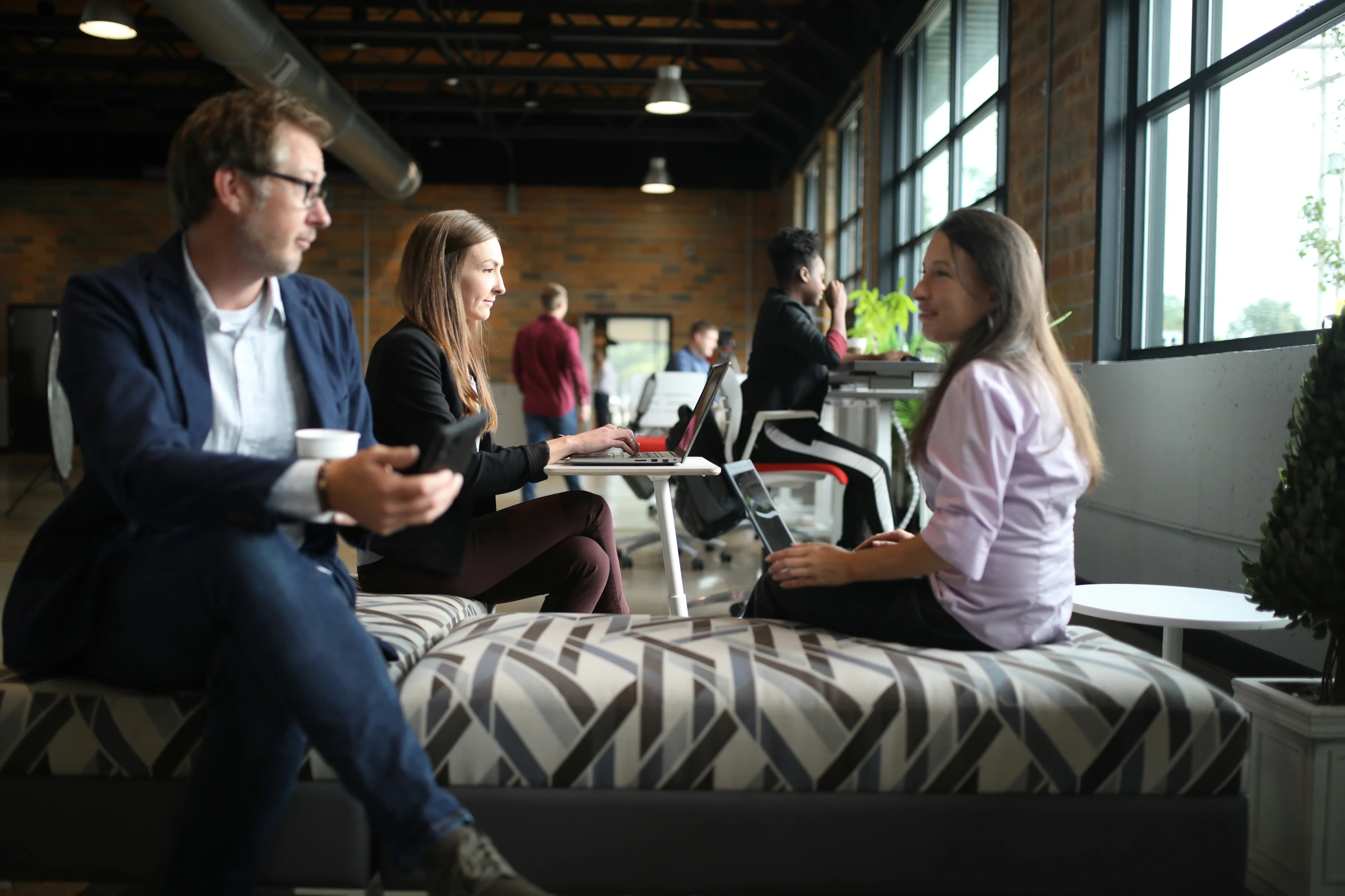 a group of people sit around talking and having a conversation