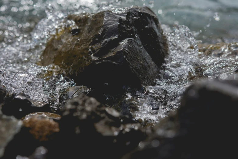 a rock sits in the middle of a body of water