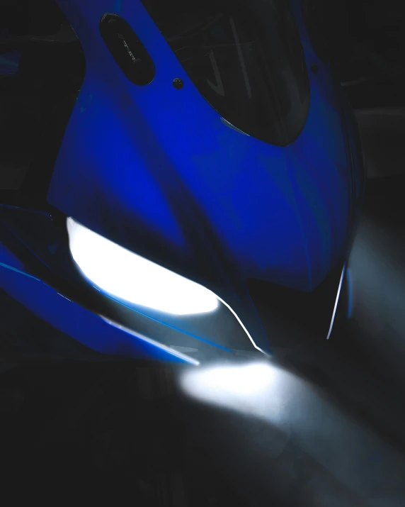 a blue motorcycle parked inside of a garage