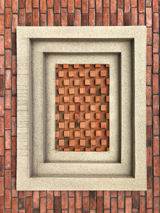a brick wall with a square hole in the middle