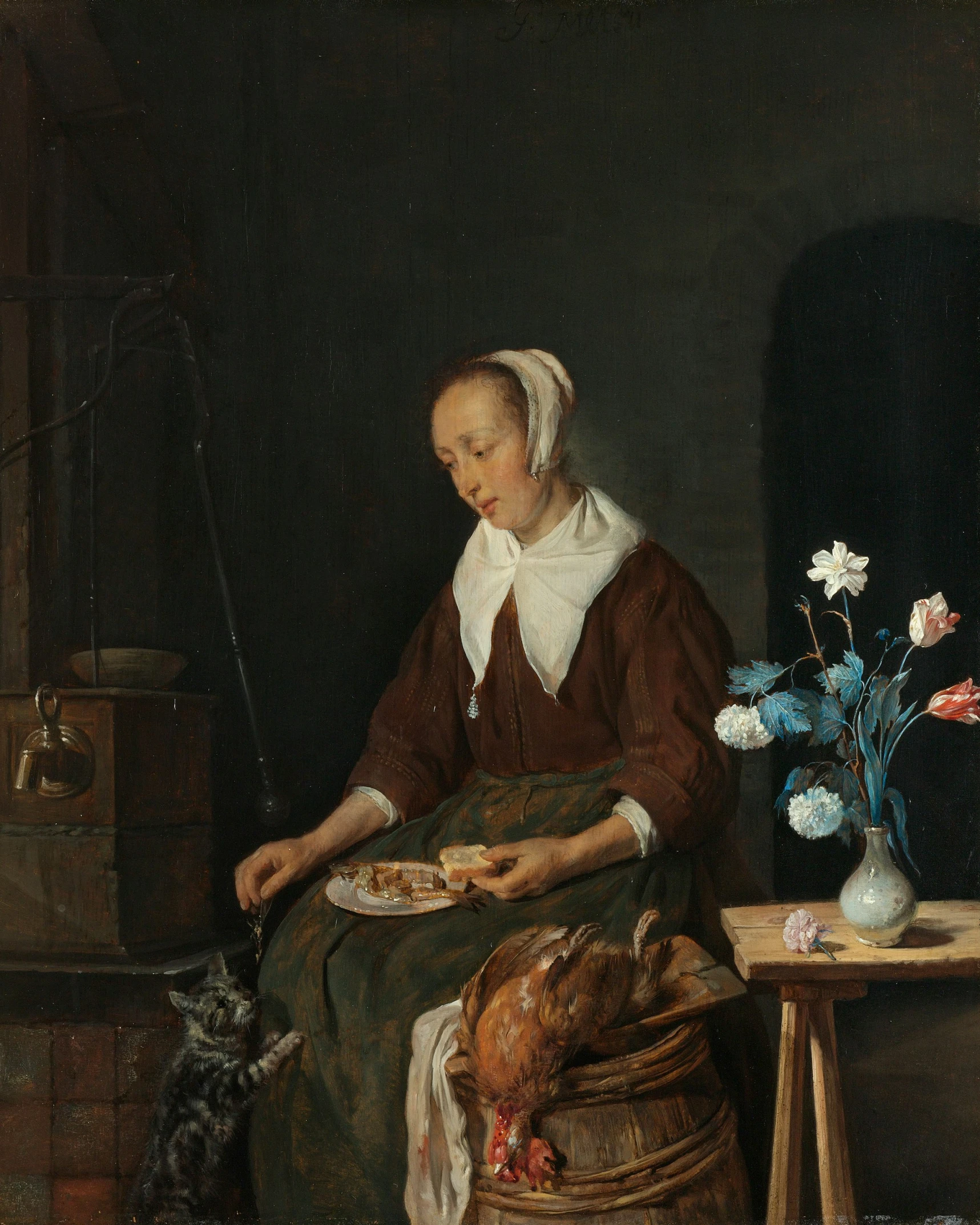 a woman sitting at a table holding a plate of food