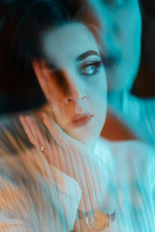 a woman with blue eyes, white shirt and black tie