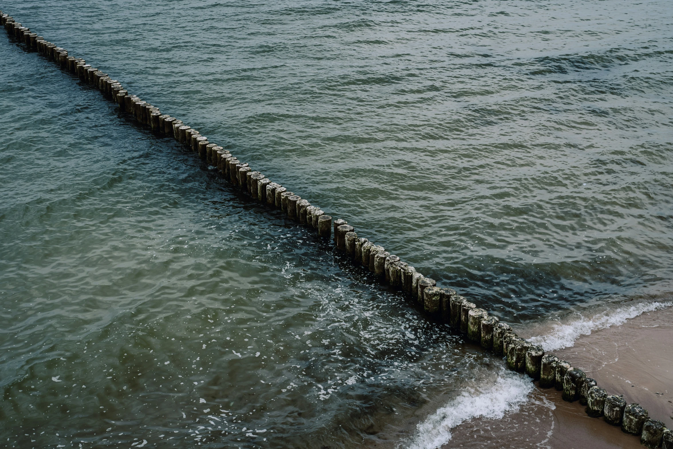 a long dock at the edge of the water