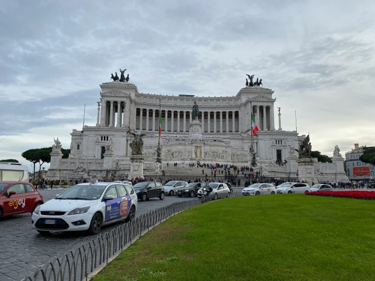 cars parked at the base of a monument