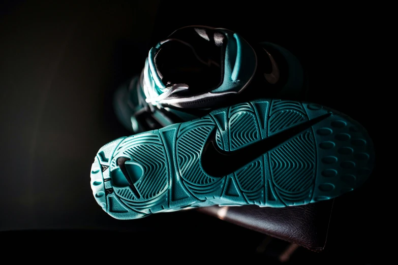 two pairs of shoes sitting on top of a metal hook