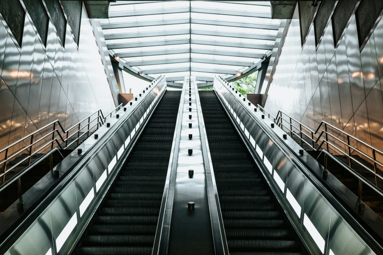 an empty and long escalator next to each other
