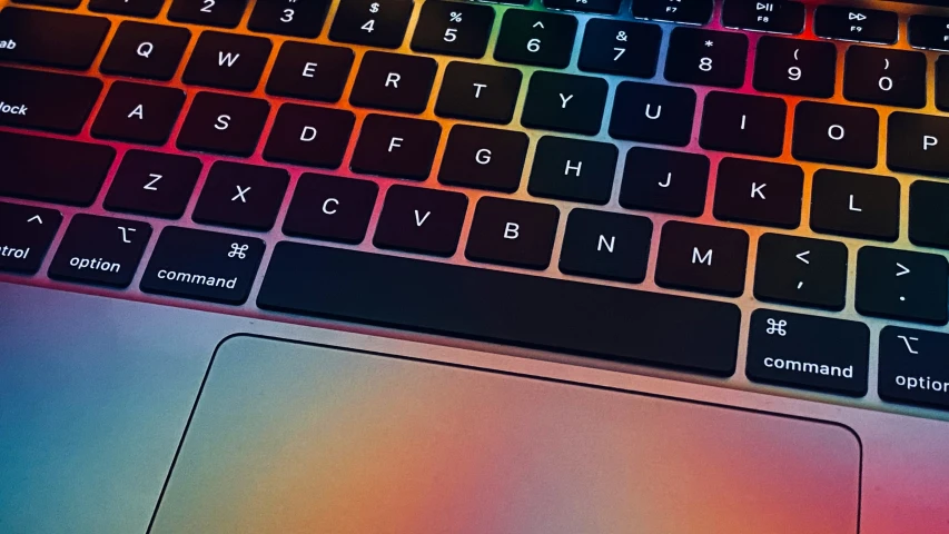 the backlit of an apple laptop with its color changing keyboard