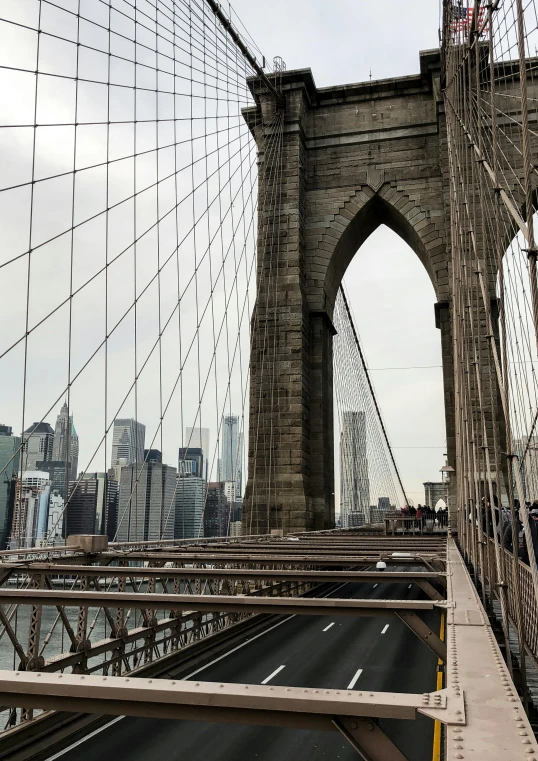 the view of a brooklyn bridge from the side of the street