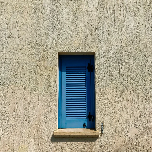 a large window and some brown and blue walls