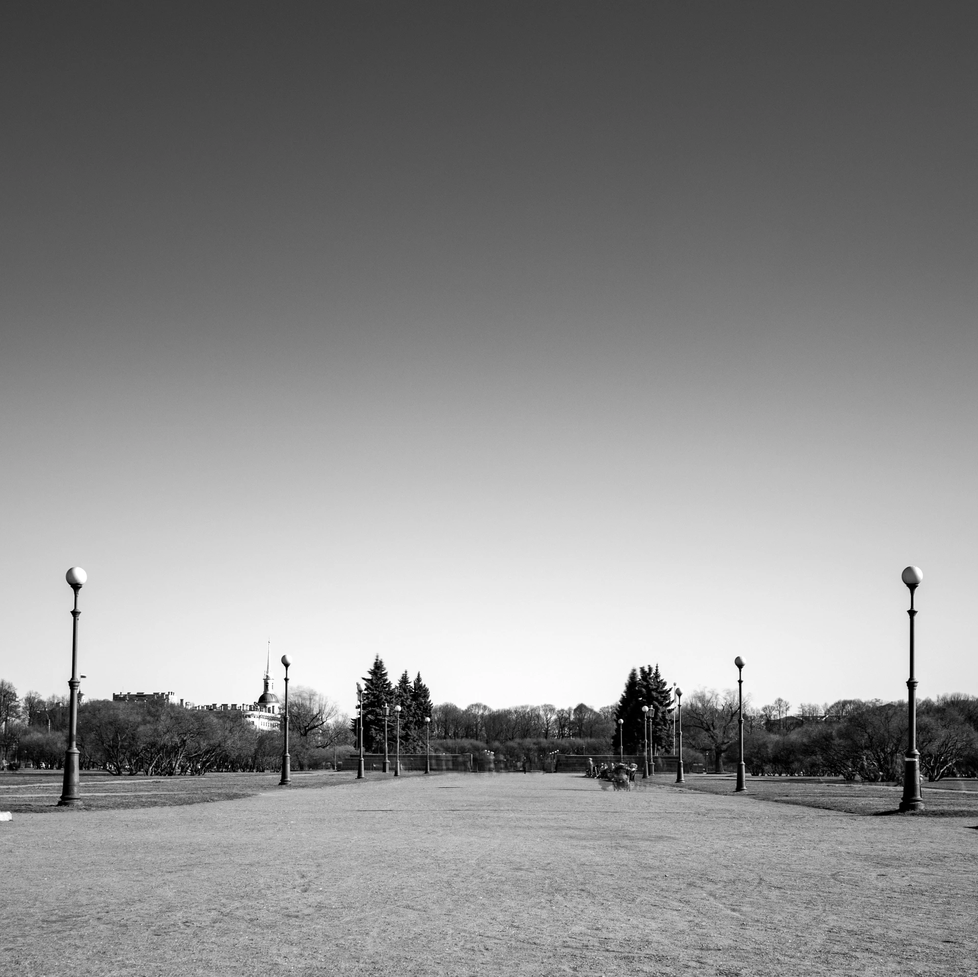 a park with street lights and two benches