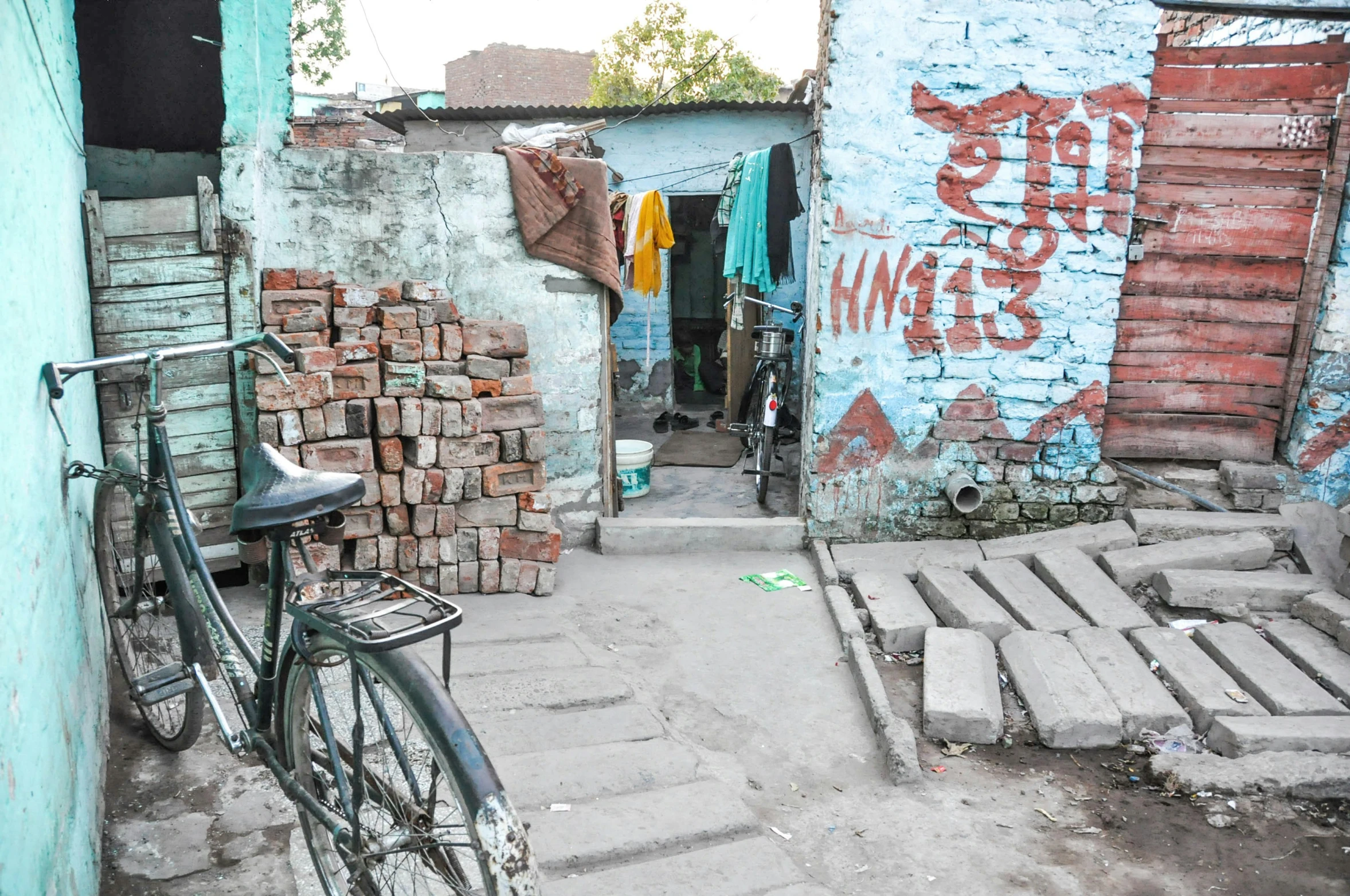 a bike parked in between buildings and street