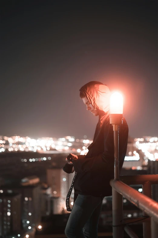 woman standing in the dark and using her camera