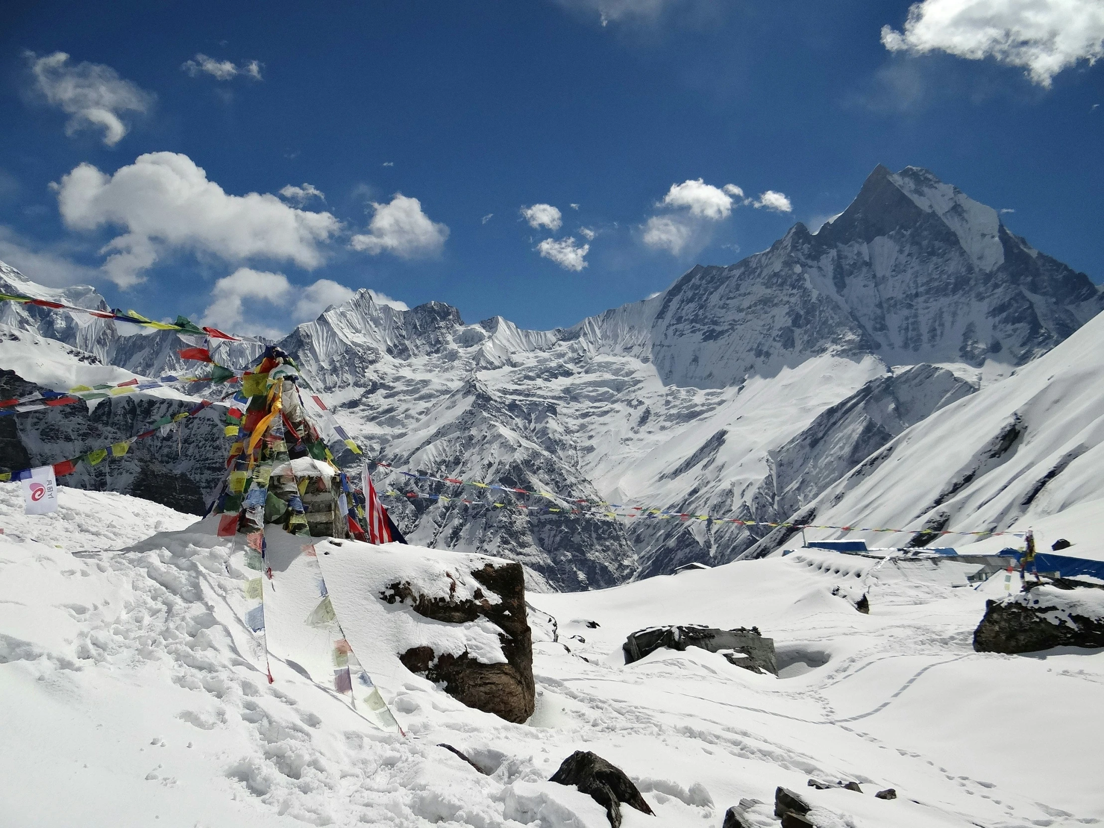 a long line of colorful flags on top of a snowy mountain