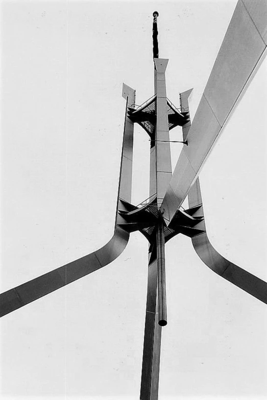 the propeller of a plane is flying against a white sky