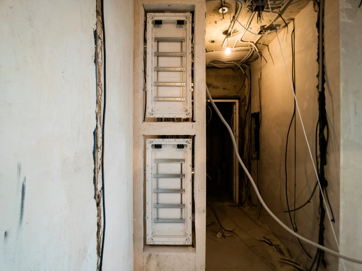 an electrical box in a dirty and run down room