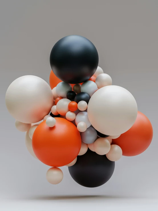 a large black object is surrounded by balls