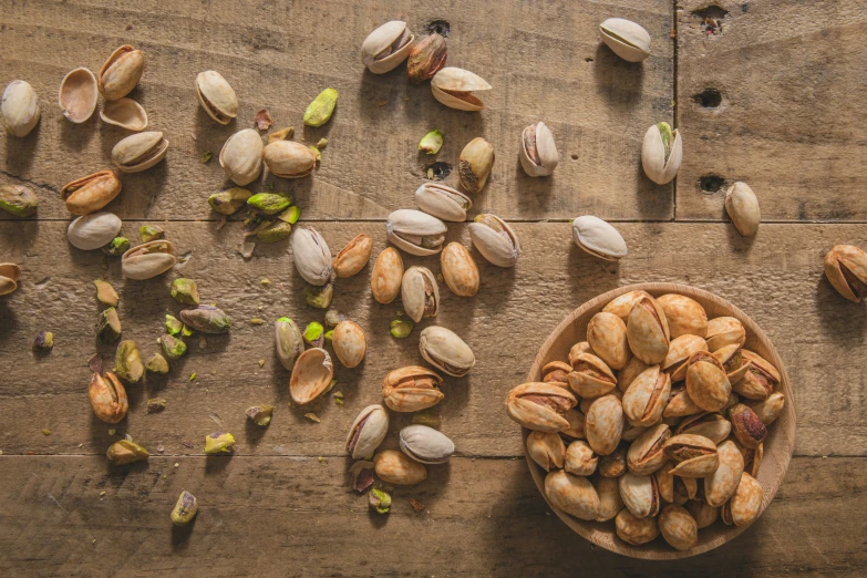 a bowl full of nuts laying next to an empty bowl of nuts