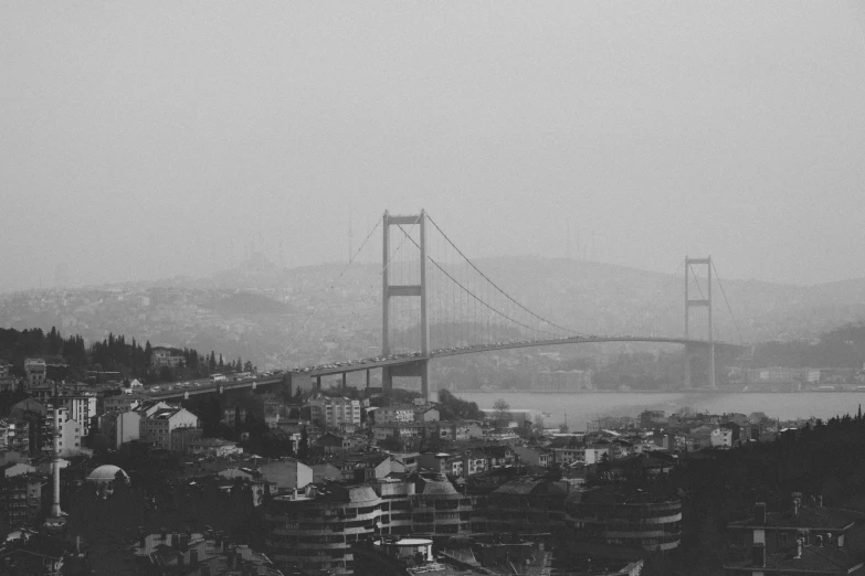 black and white pograph of a bridge and city