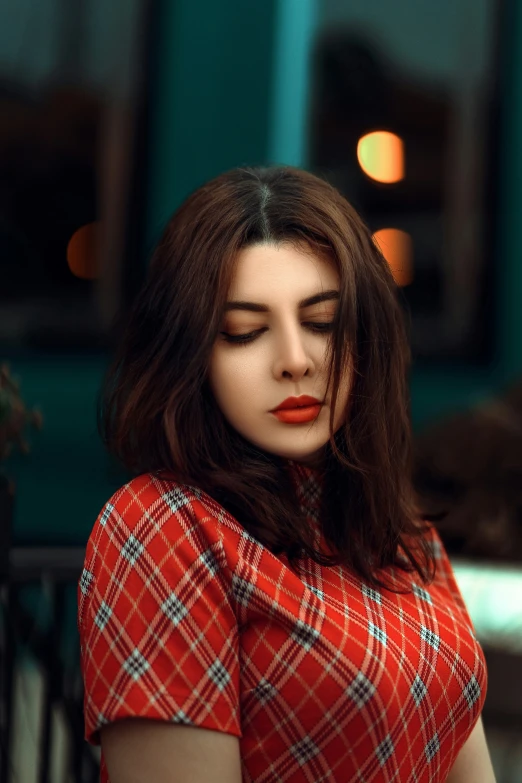 young woman with red lipstick looking over her shoulder