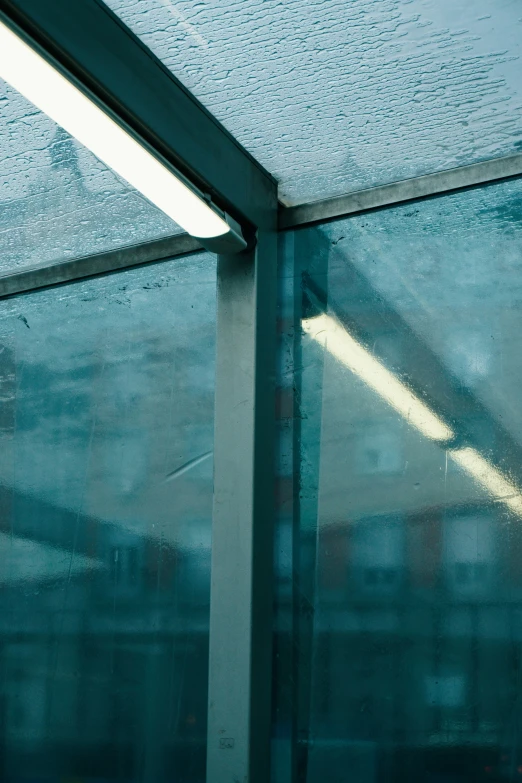 a window next to a road with rain on it