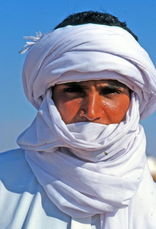 a man with a white head covering his face