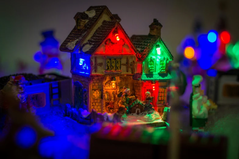 small lighted houses in a row with lights on them