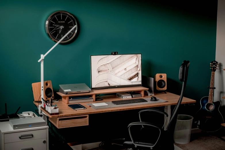 a wooden desk topped with a computer monitor and keyboard