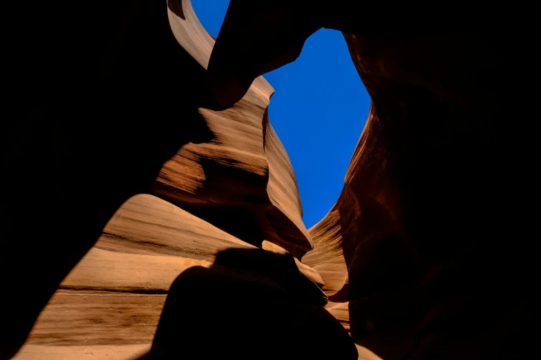 looking at the shadow of one person, from the bottom of a cliff