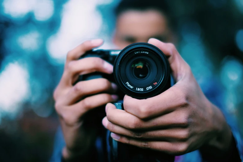 the camera man is holding up his new canon s