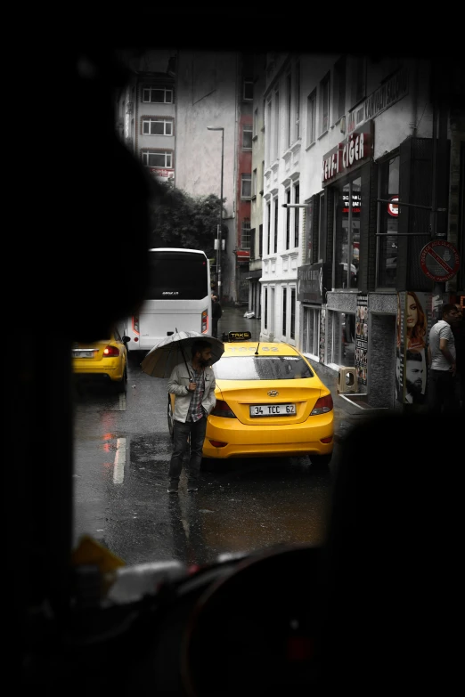 yellow taxi cabs and pedestrians crossing in the rain