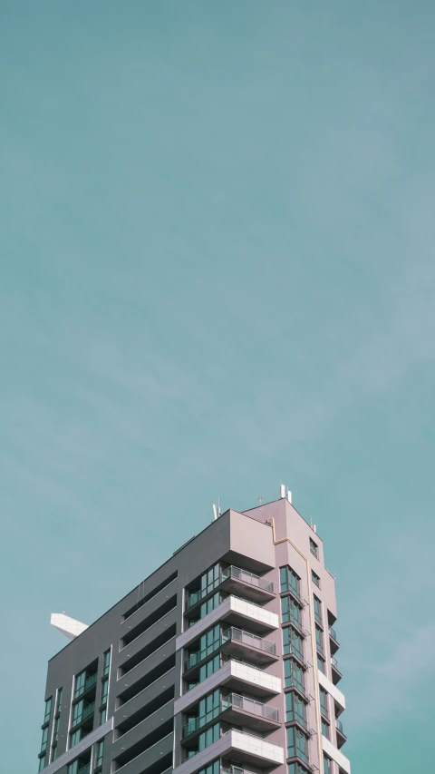 a large building with a plane flying in the sky