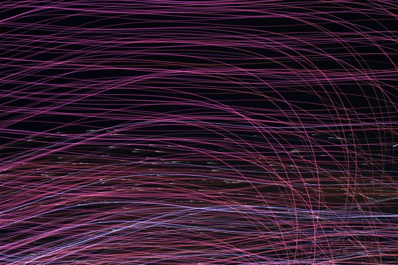 light streams over a black background in pink