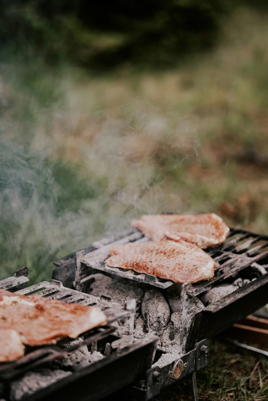  dog buns being grilled on the grill with smoke rising from it