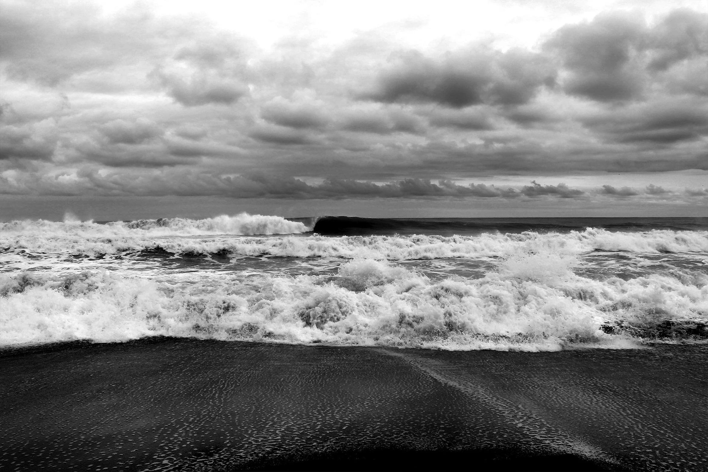 a man with a surfboard looking out at the waves