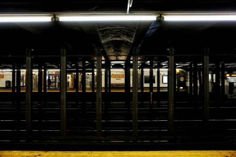 a train sitting on tracks near a loading platform