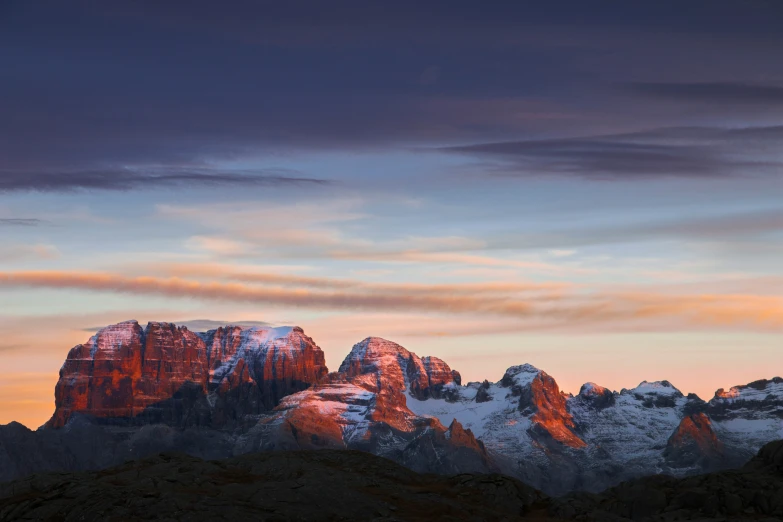 an orange, white and grey sky in the distance